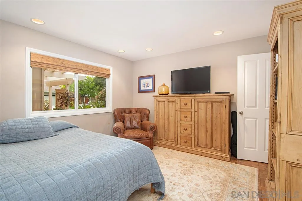 2224 Caminito Cabala La Jolla, CA 92037 - Photo 21 of 36 a bedroom with a bed and a flat screen tv