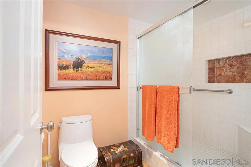 2224 Caminito Cabala La Jolla, CA 92037 - Photo 24 of 36 a bathroom with a toilet and a painting on the wall