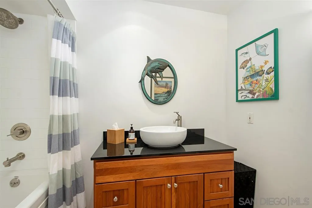 2224 Caminito Cabala La Jolla, CA 92037 - Photo 25 of 36 a bathroom with a toilet a sink and a mirror