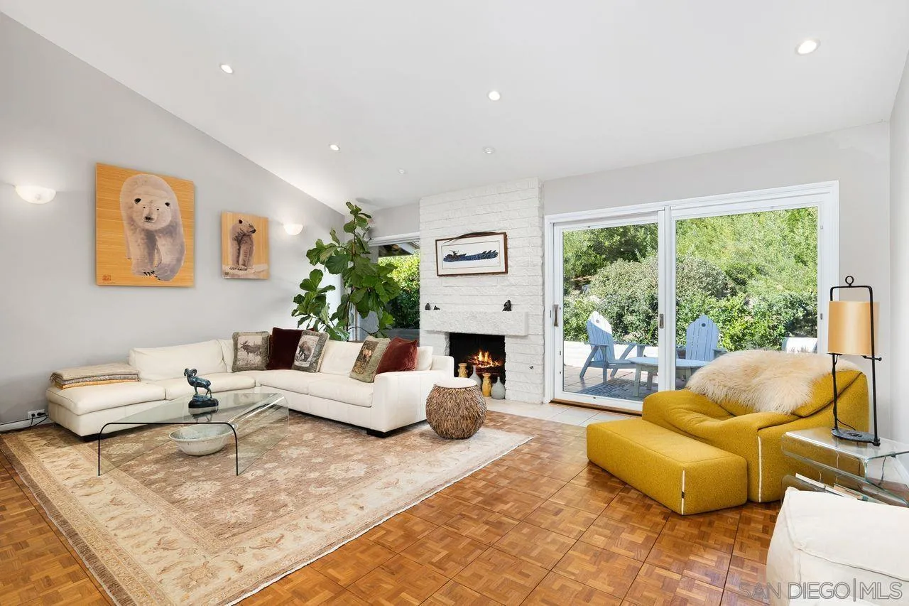 2224 Caminito Cabala La Jolla, CA 92037 - Photo 6 of 36 a living room with fireplace furniture and a large window