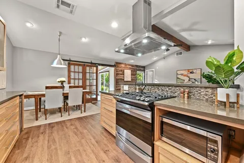 a kitchen with stainless steel appliances granite countertop lots of counter top space