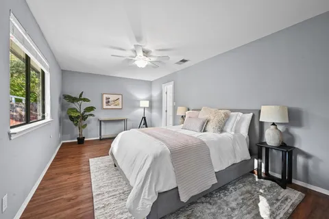 a bed room with a bed and a chandelier