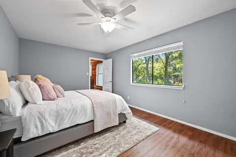 a bedroom with a large bed and a window