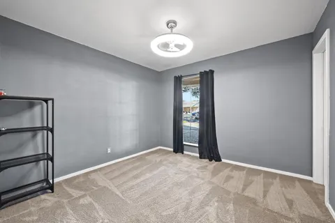 an empty room with windows and closet