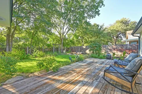 a view of a backyard with sitting area