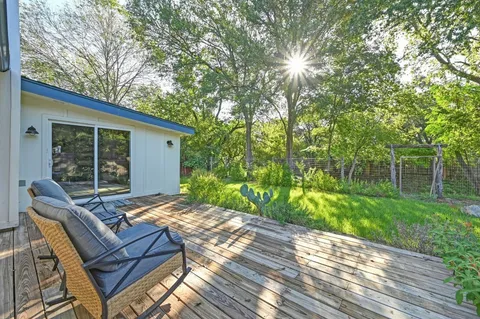 a view of backyard with outdoor seating and green space
