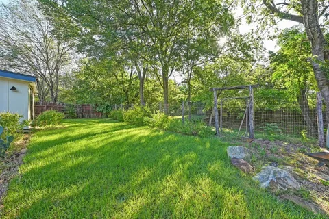 a view of a backyard with large trees
