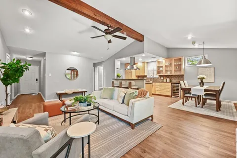 a living room with furniture and wooden floor