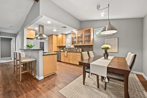 a dining room with furniture and wooden floor