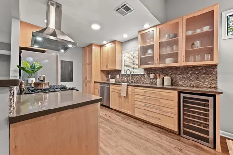a kitchen with stainless steel appliances granite countertop a sink stove and cabinets