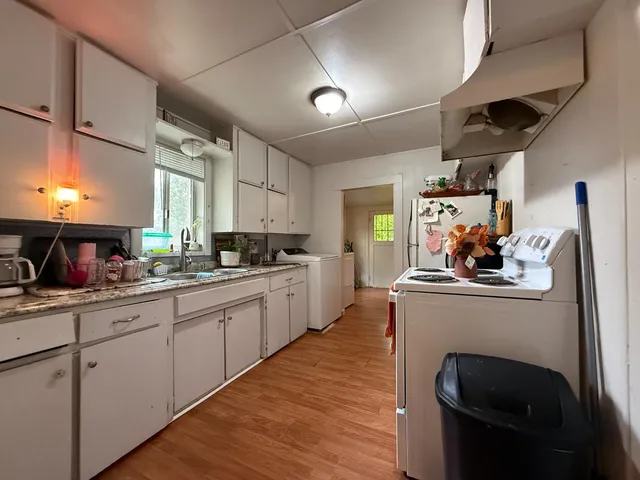 a bedroom with bed and a chandelier