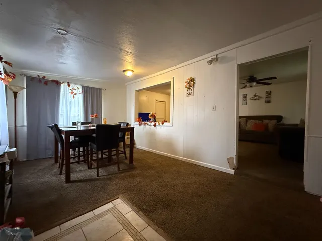 a bathroom with a sink a toilet and shower curtain