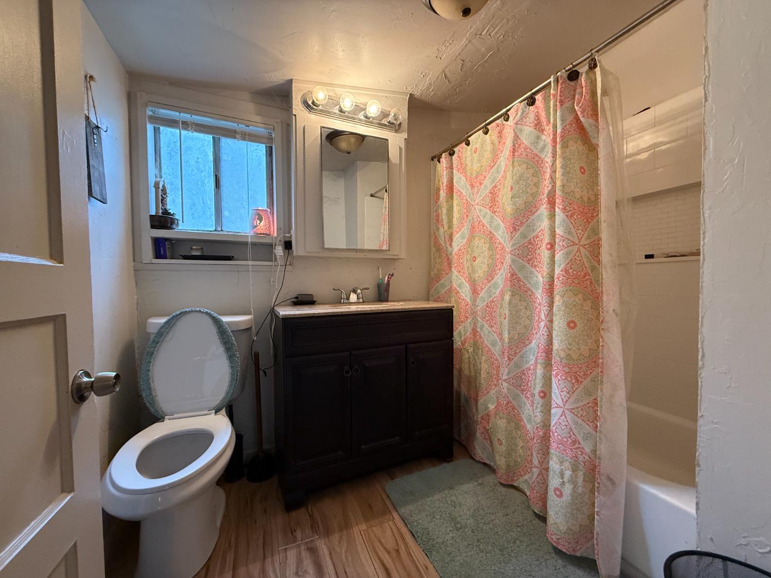 4621 Swanson Road Denair, CA 95316 - Photo 22 of 57 a bathroom with a sink a toilet and shower curtain