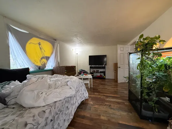 a bedroom with a bed and a window