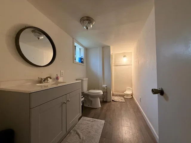 a living room with furniture kitchen view and a large window