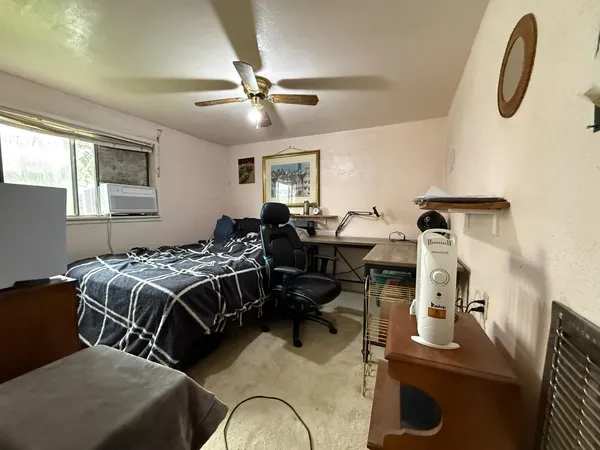 a bedroom with a bed and a window