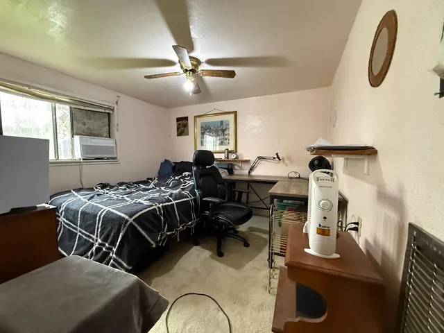 a bedroom with a bed and a window