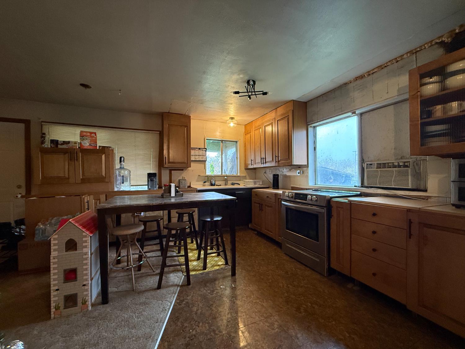 4621 Swanson Road Denair, CA 95316 - Photo 42 of 57 a kitchen with stainless steel appliances granite countertop a stove a sink dishwasher and a dining table with wooden cabinet