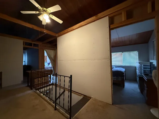a bathroom with a granite countertop sink toilet and a mirror