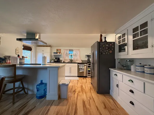 a bathroom with a granite countertop sink mirror vanity and toilet