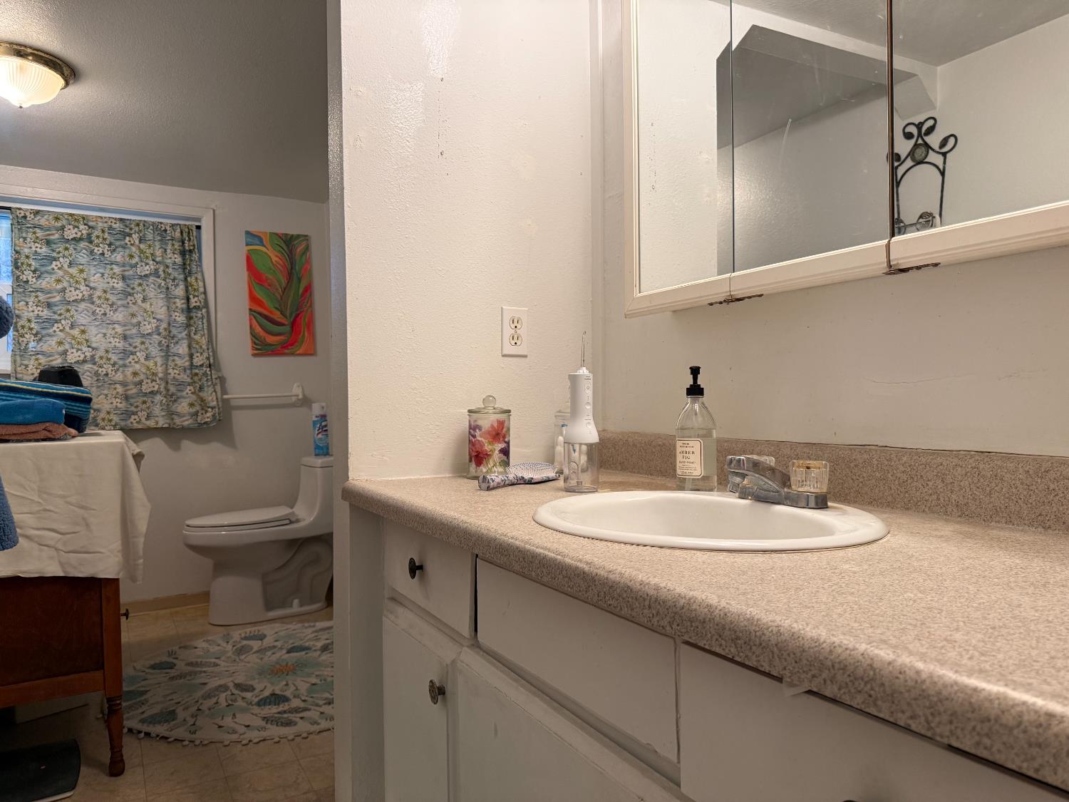 4621 Swanson Road Denair, CA 95316 - Photo 8 of 57 a bathroom with a granite countertop sink mirror vanity and toilet