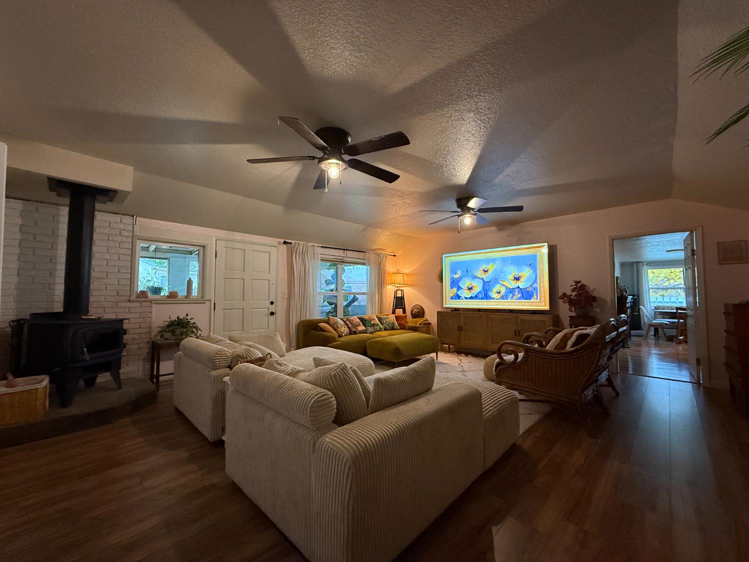 4621 Swanson Road Denair, CA 95316 - Photo 10 of 57 a living room with furniture a ceiling fan and a flat screen tv