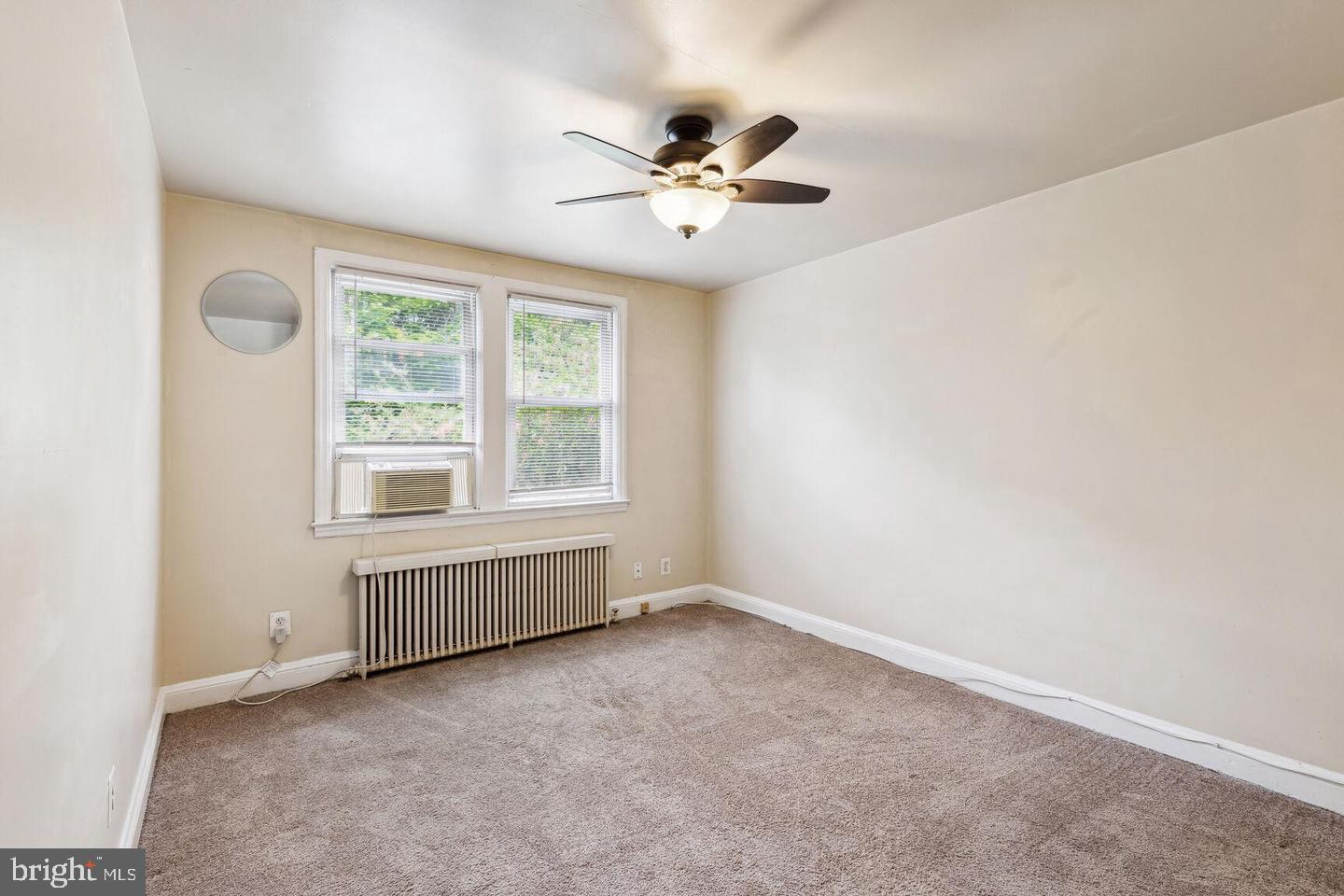 902 Elm Ridge Avenue Baltimore, MD 21229 - Photo 11 of 15 an empty room with windows and fan