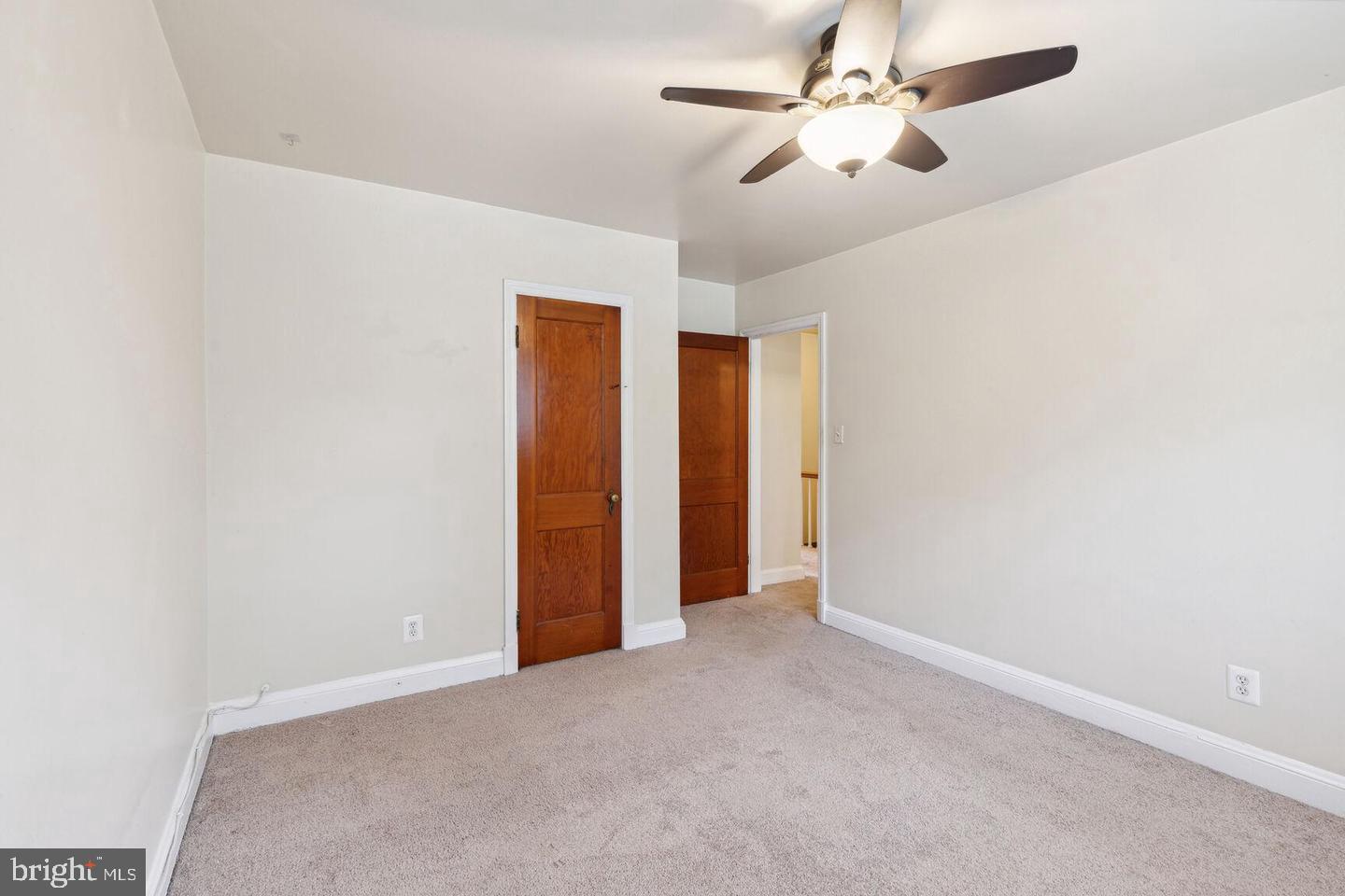 902 Elm Ridge Avenue Baltimore, MD 21229 - Photo 13 of 15 an empty room with closet and a chandelier fan