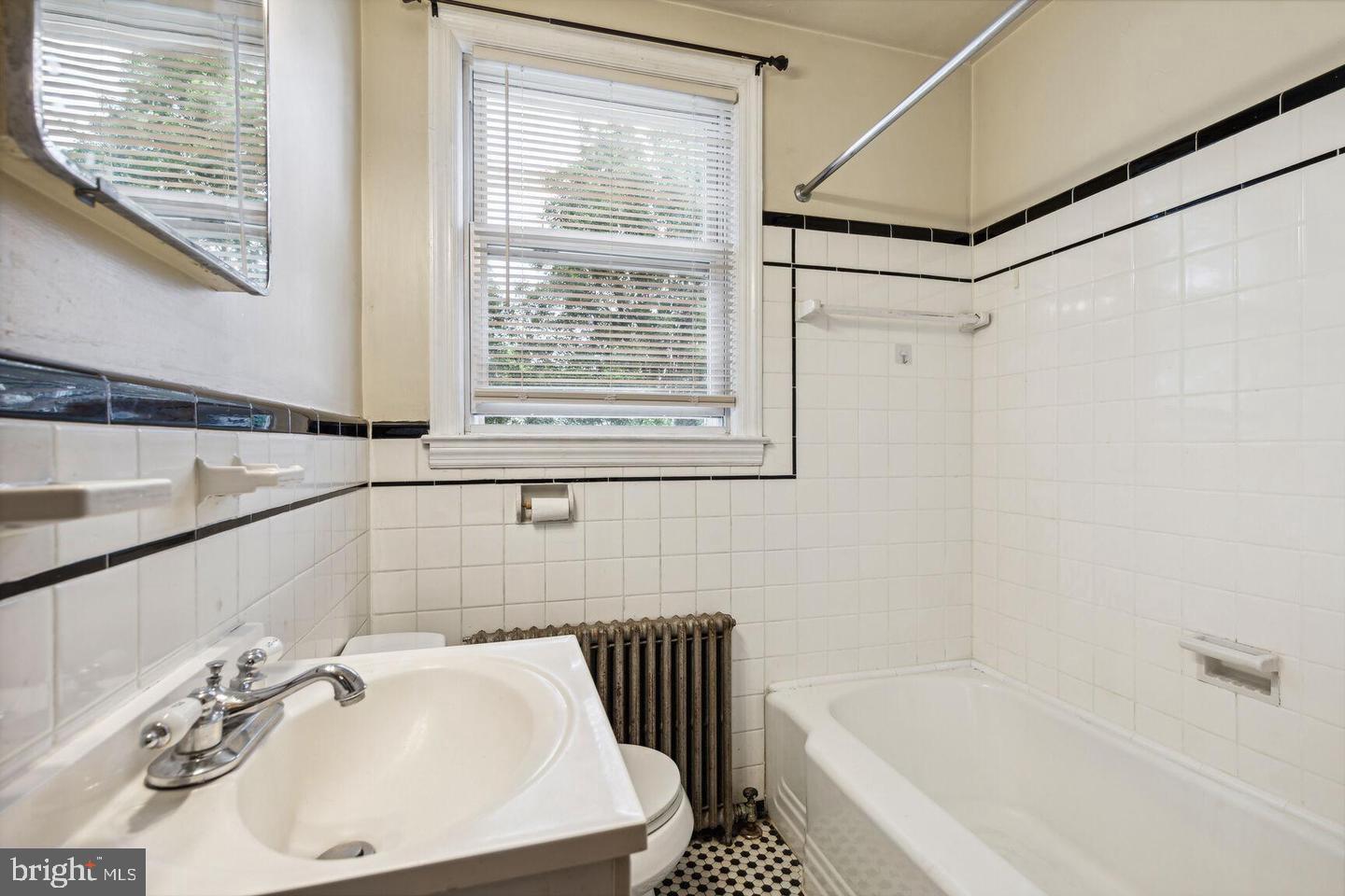 902 Elm Ridge Avenue Baltimore, MD 21229 - Photo 15 of 15 a bathroom with a sink and a bathtub