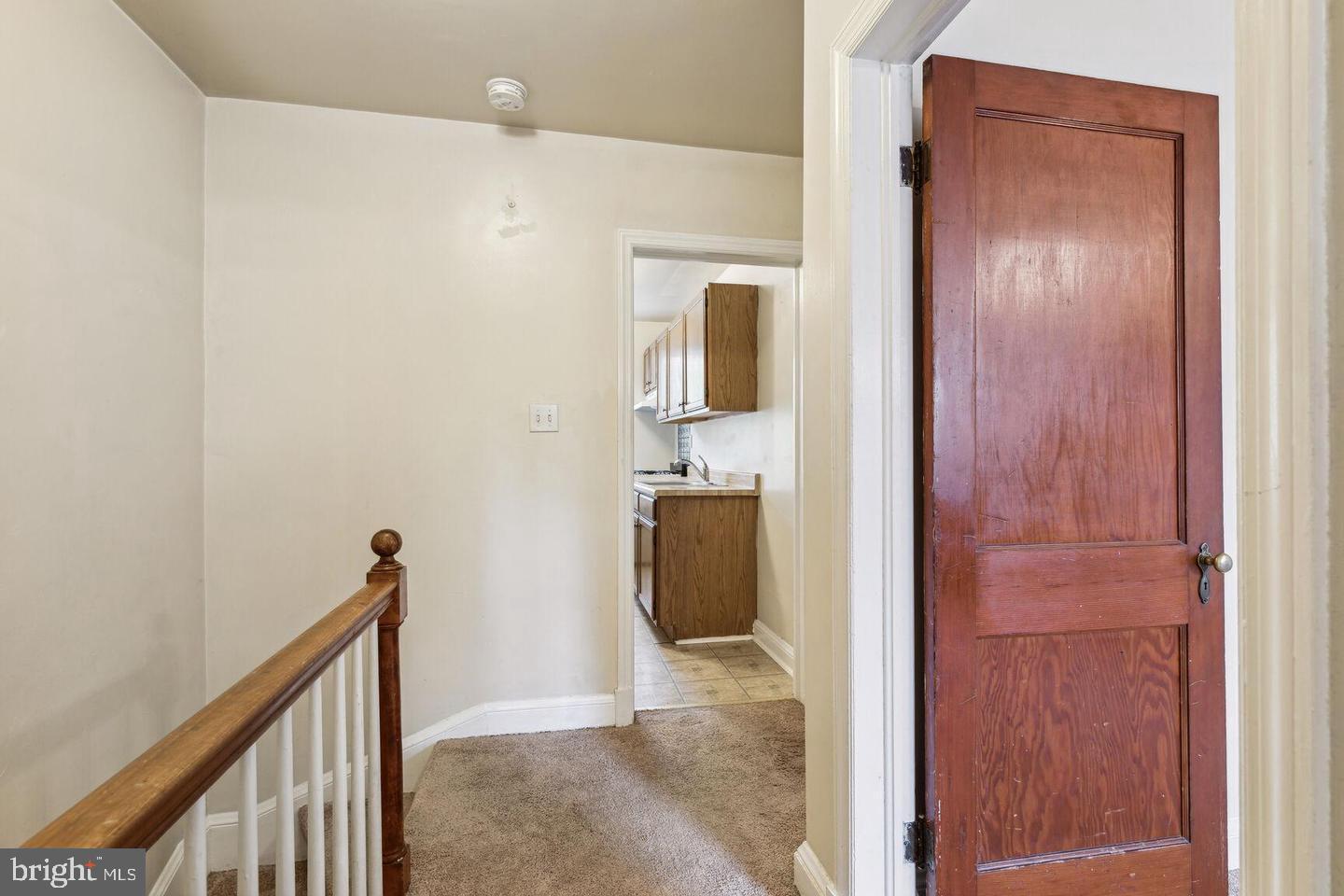 902 Elm Ridge Avenue Baltimore, MD 21229 - Photo 8 of 15 a view of a hallway with wooden floor and staircase