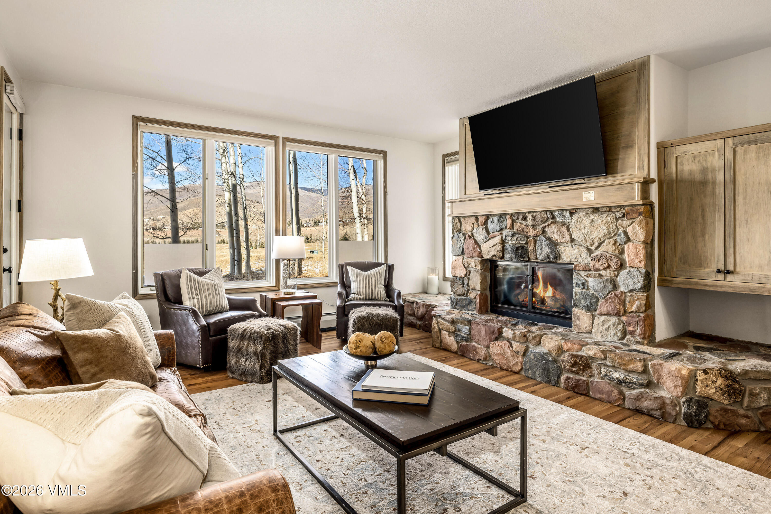 600 Sawatch Drive, Unit 101 Edwards, CO 81632 - Photo 1 of 34 a living room with furniture a flat screen tv and a fireplace
