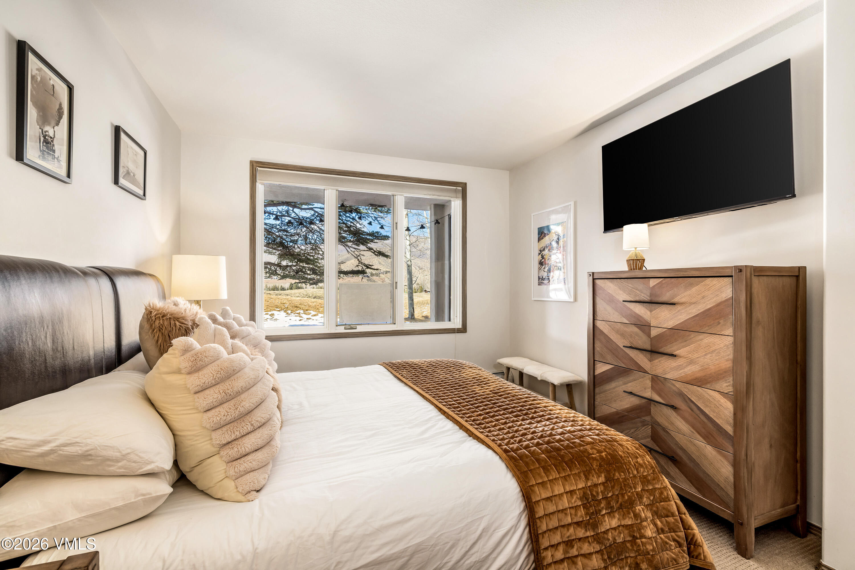 600 Sawatch Drive, Unit 101 Edwards, CO 81632 - Photo 12 of 34 a bedroom with a large bed and a flat screen tv