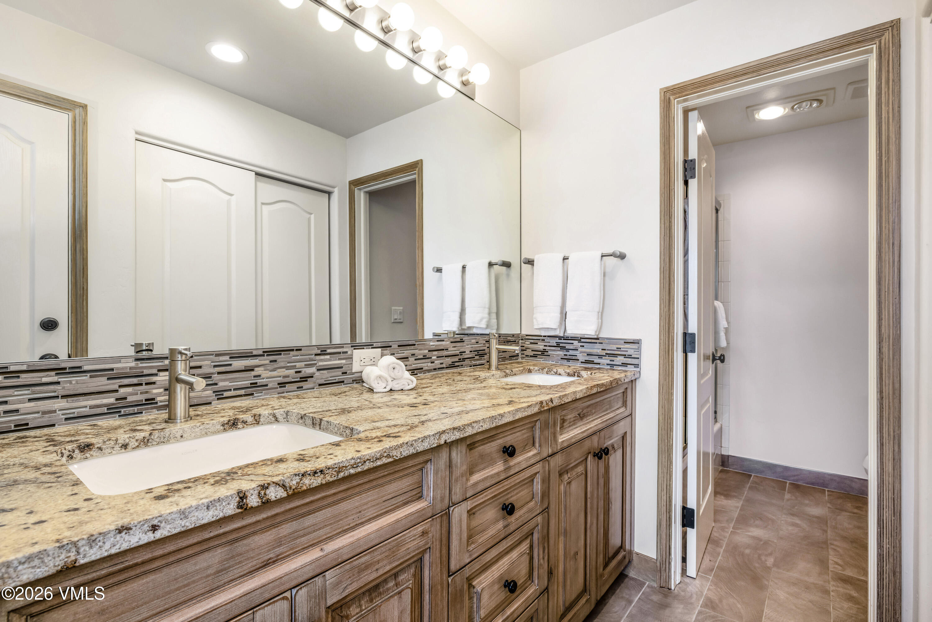 600 Sawatch Drive, Unit 101 Edwards, CO 81632 - Photo 13 of 34 a bathroom with a granite countertop sink and a mirror