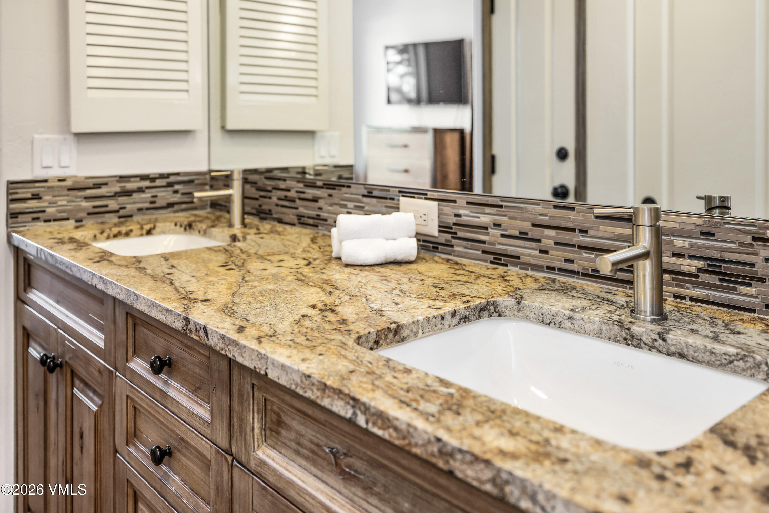 600 Sawatch Drive, Unit 101 Edwards, CO 81632 - Photo 14 of 34 a bathroom with a granite countertop sink and a mirror