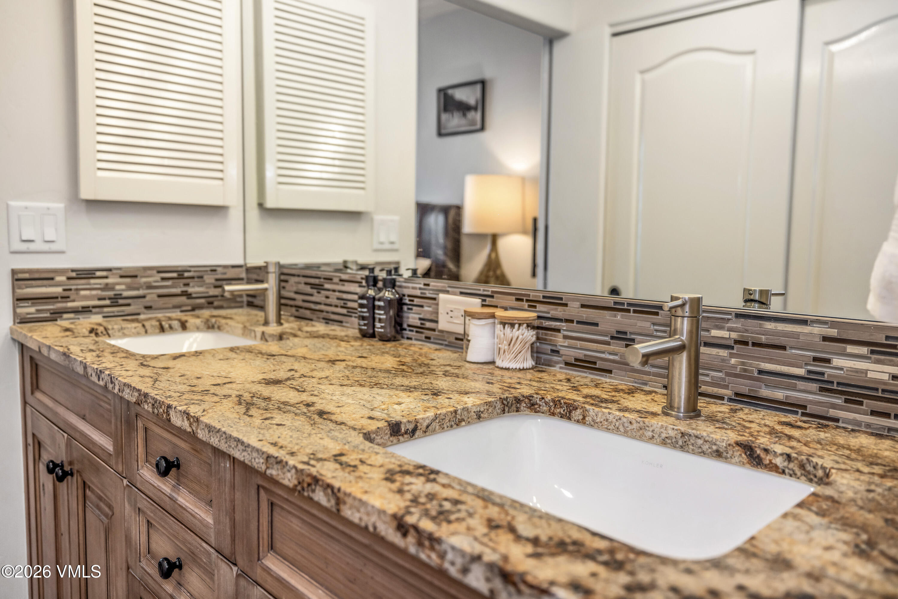 600 Sawatch Drive, Unit 101 Edwards, CO 81632 - Photo 17 of 34 a bathroom with a granite countertop sink and a mirror