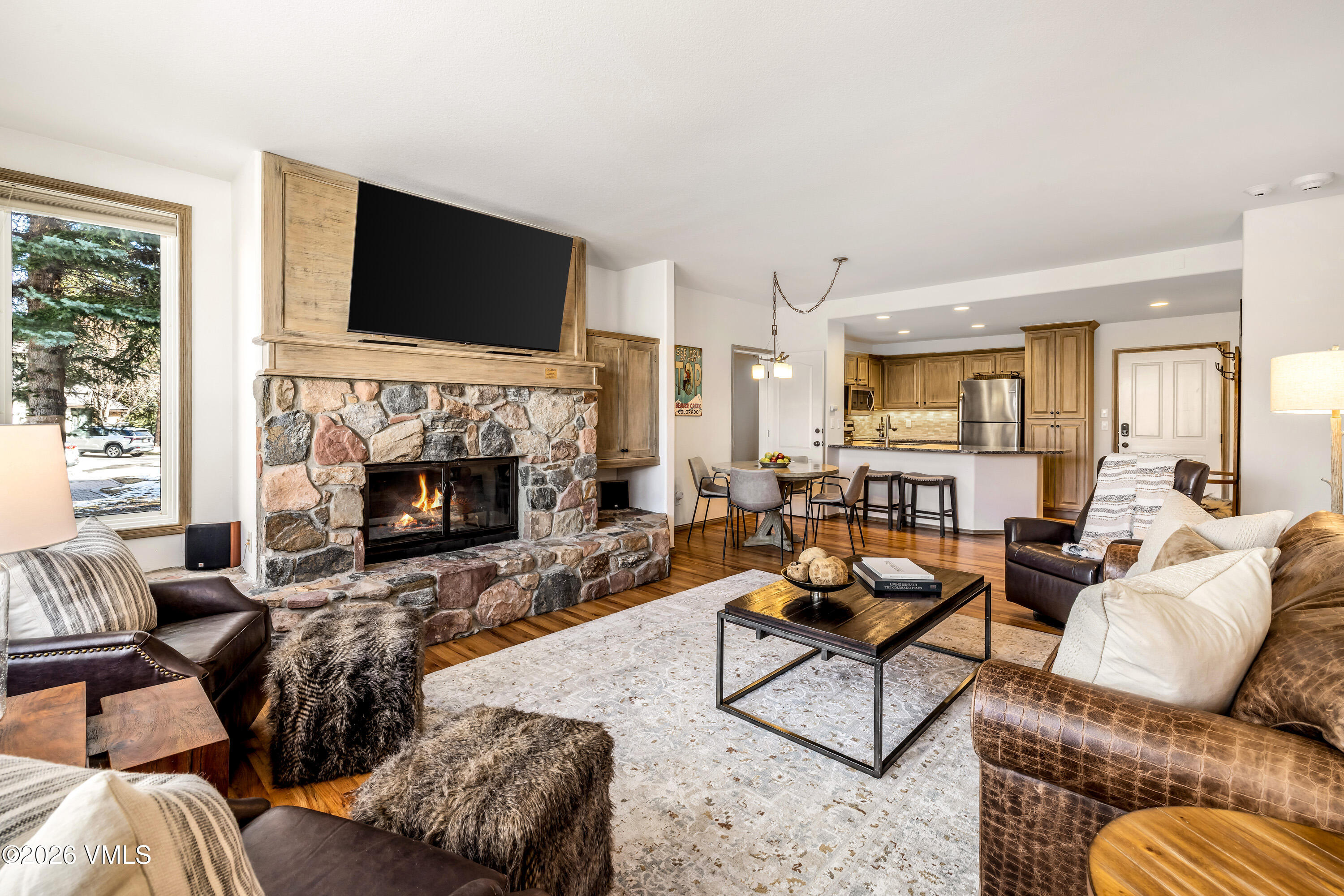 600 Sawatch Drive, Unit 101 Edwards, CO 81632 - Photo 31 of 34 a living room with furniture flat screen tv and a fireplace
