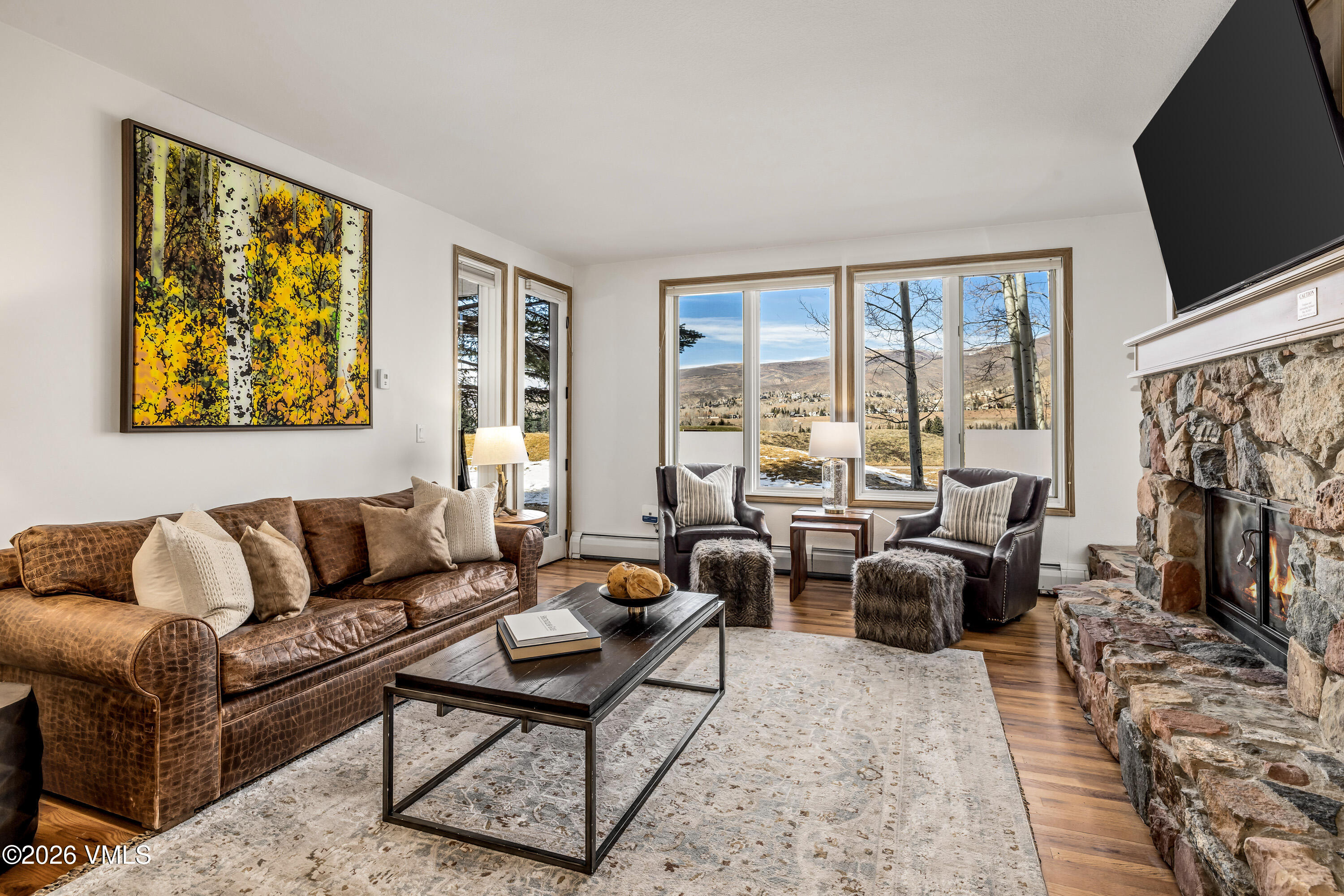 600 Sawatch Drive, Unit 101 Edwards, CO 81632 - Photo 4 of 34 a living room with furniture a flat screen tv and a fireplace