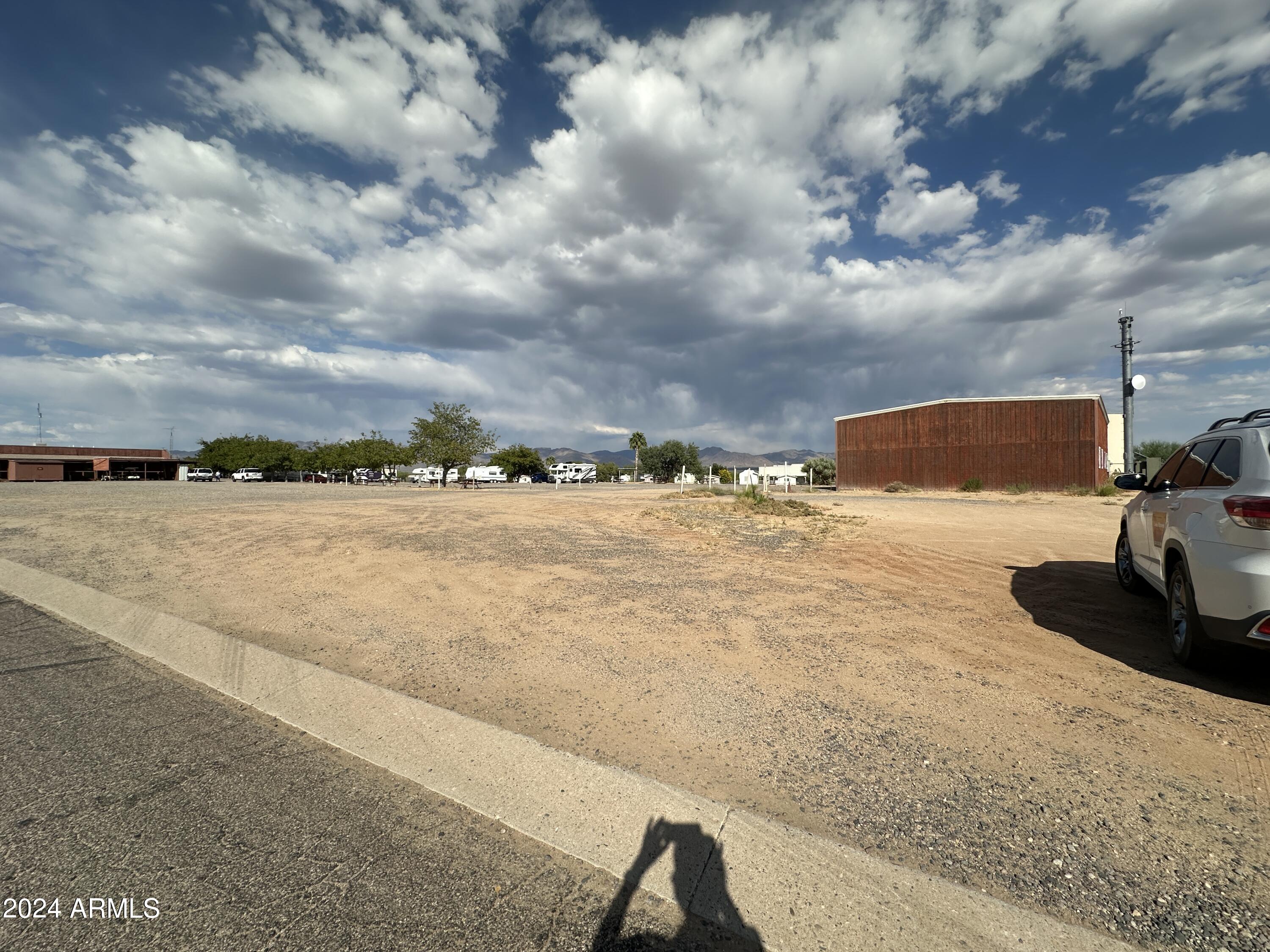 30530 Burnt Sage Road, Unit 278 Congress, AZ 85332 - Photo 13 of 13 a view of swimming pool with lawn chairs and iron fence
