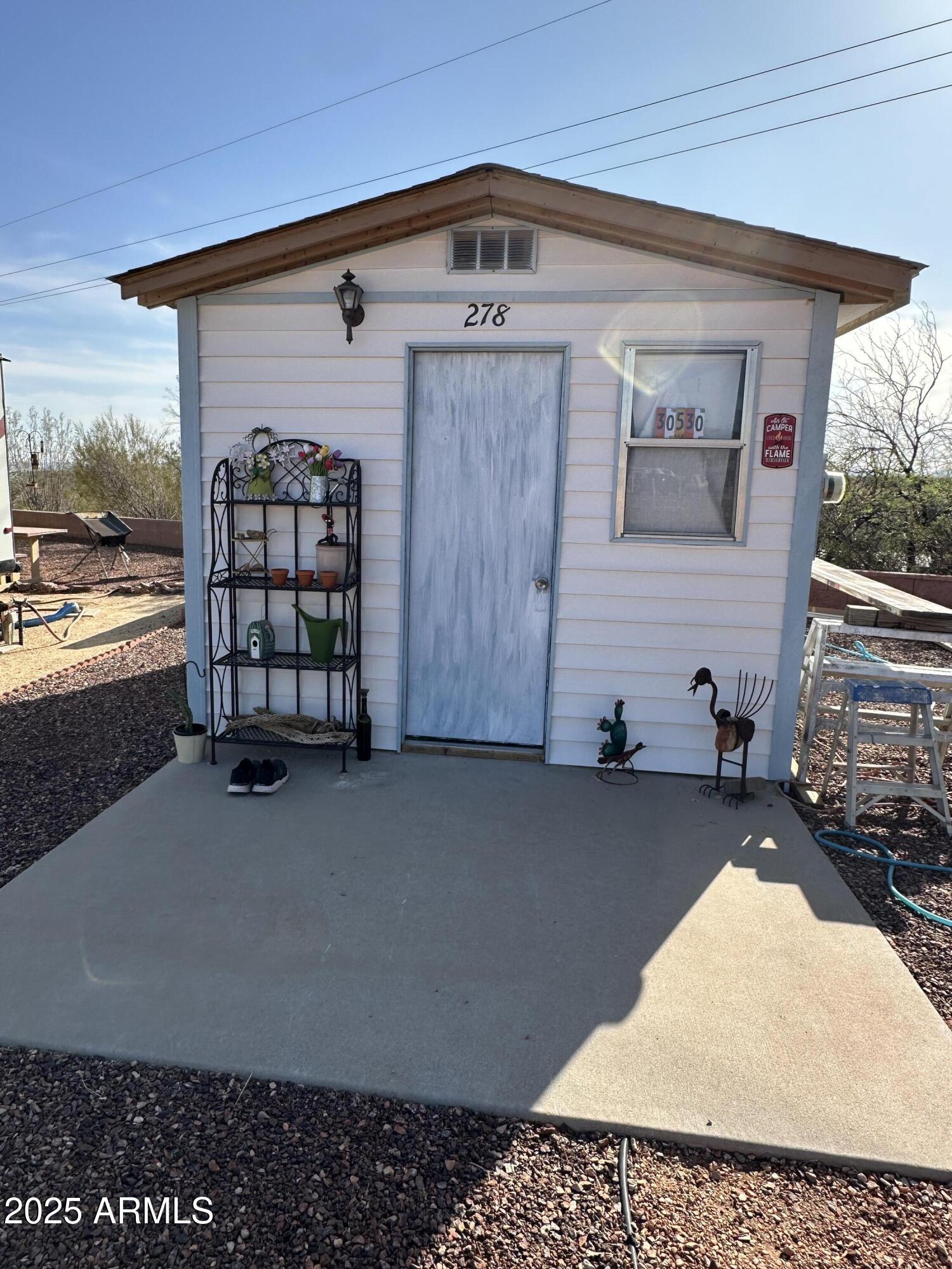 30530 Burnt Sage Road, Unit 278 Congress, AZ 85332 - Photo 5 of 13 a front view of a house with garden