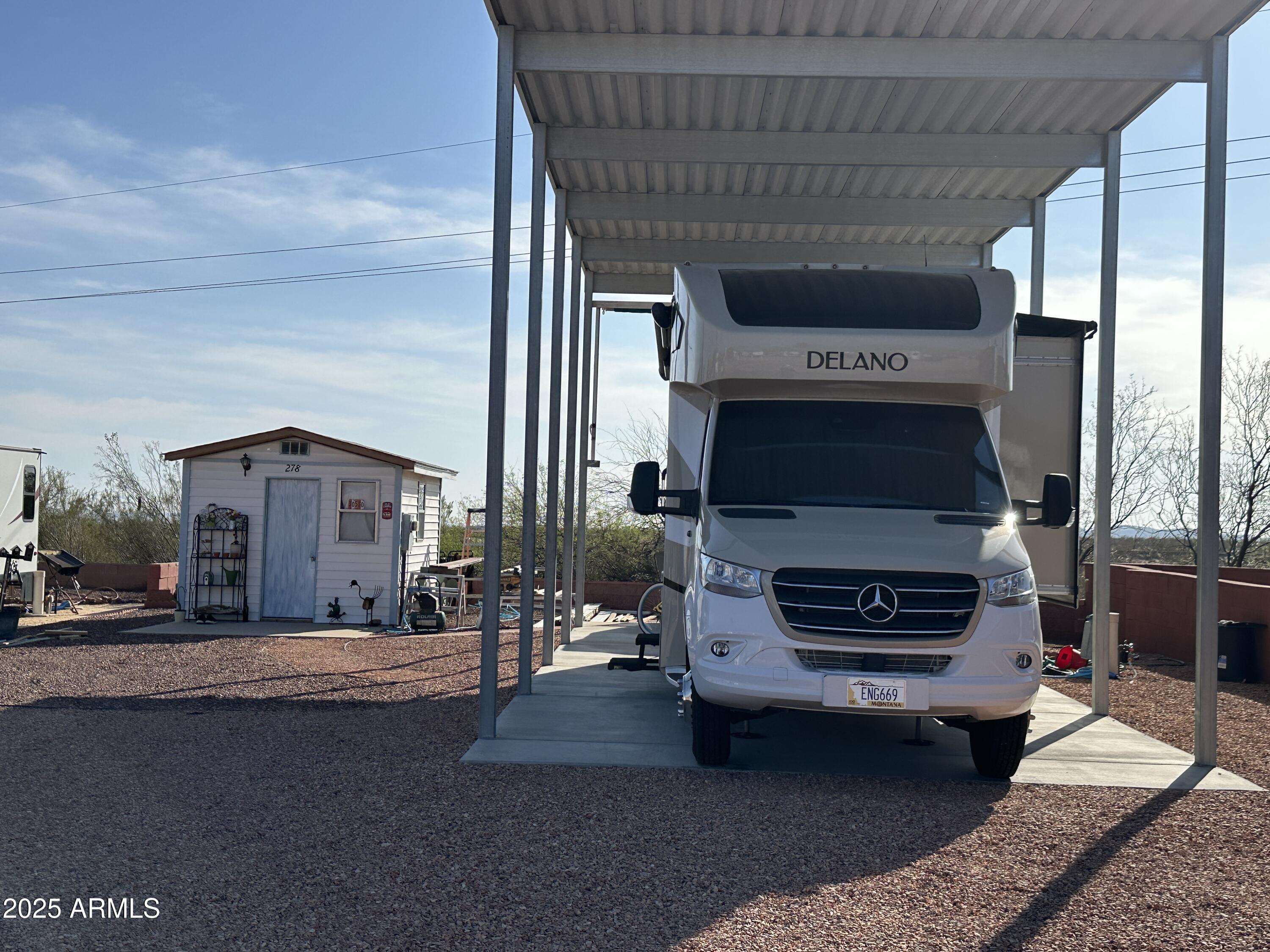 30530 Burnt Sage Road, Unit 278 Congress, AZ 85332 - Photo 10 of 13 a living room with furniture a fireplace and a flat screen tv