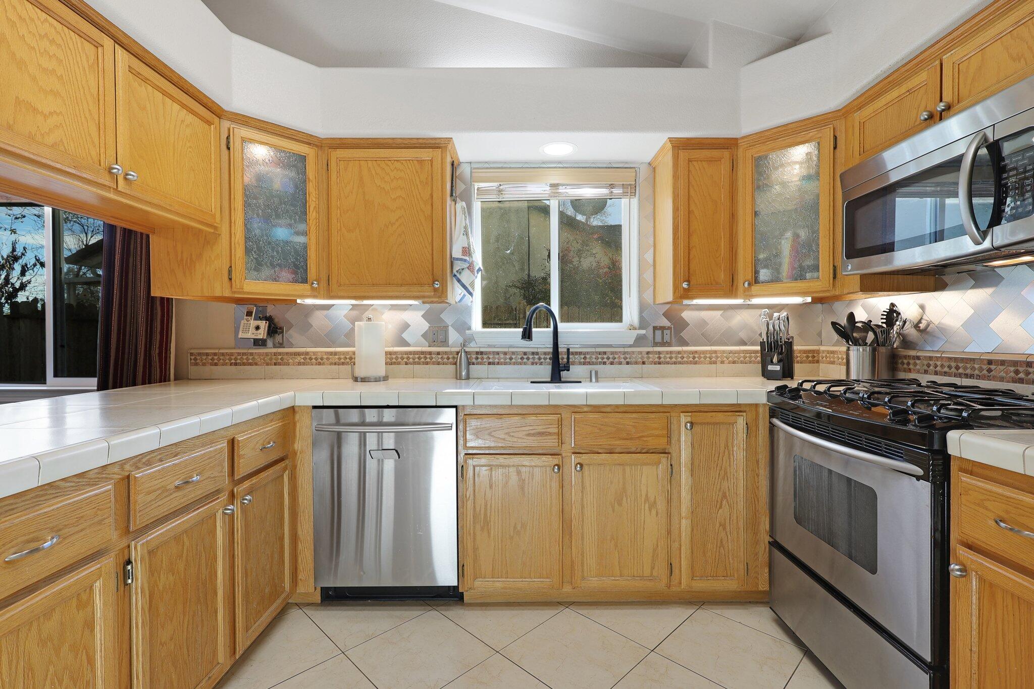 3375 Lawrence Road Redding, CA 96002 - Photo 12 of 46 a kitchen with stainless steel appliances granite countertop a stove sink and cabinets