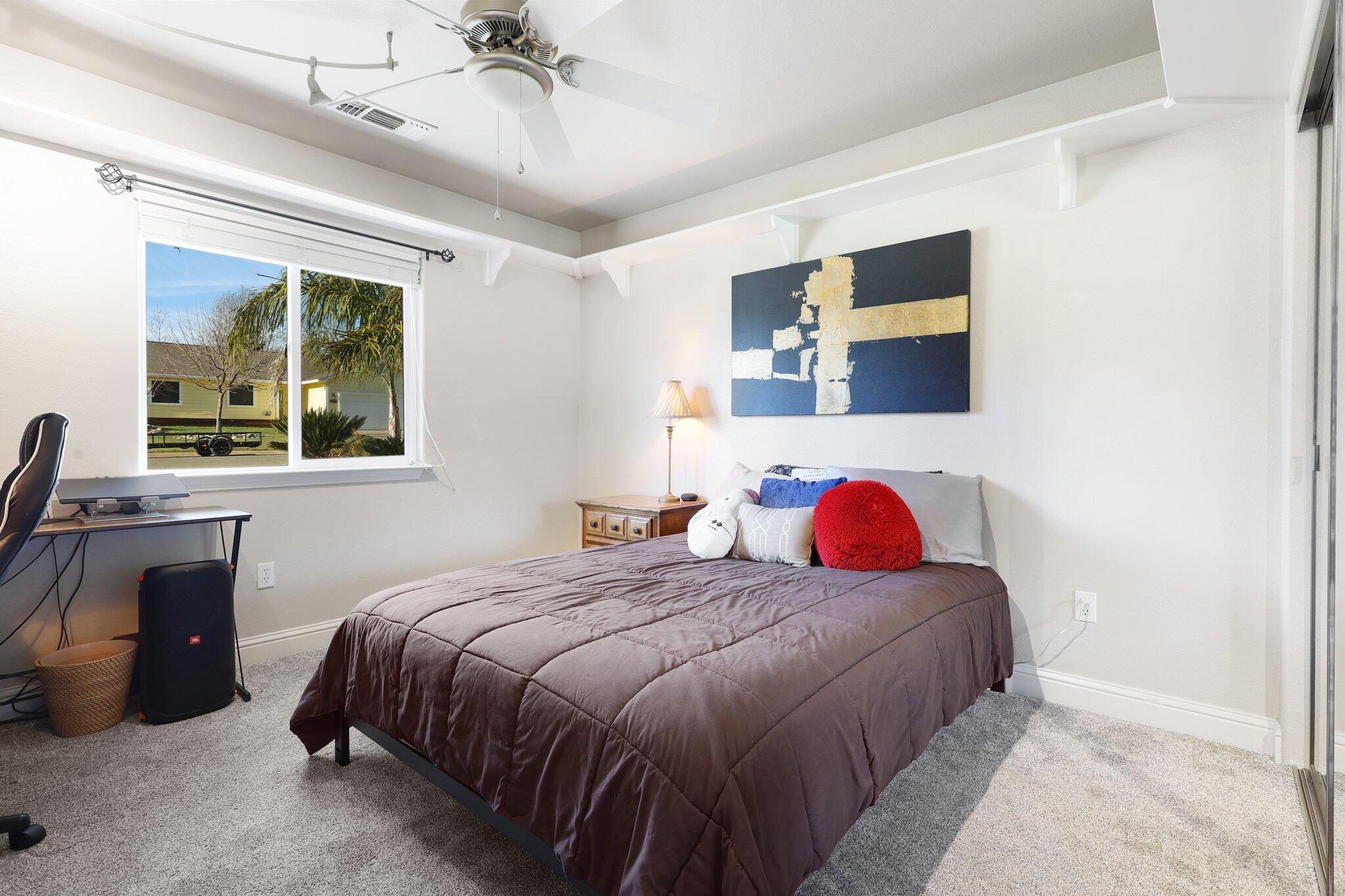 3375 Lawrence Road Redding, CA 96002 - Photo 22 of 46 a bedroom with a bed and a chandelier