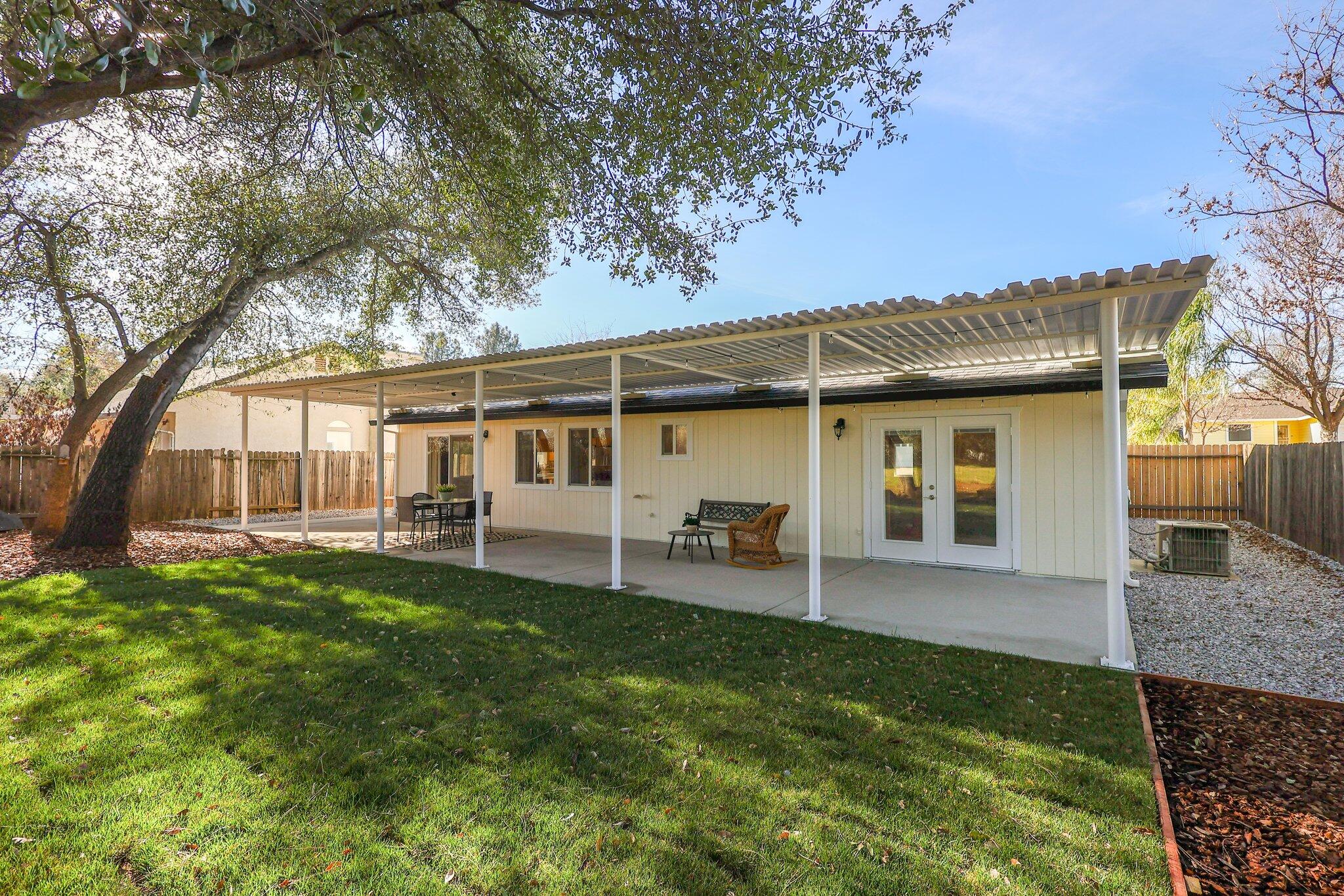 3375 Lawrence Road Redding, CA 96002 - Photo 28 of 46 a view of a house with a backyard porch and sitting area