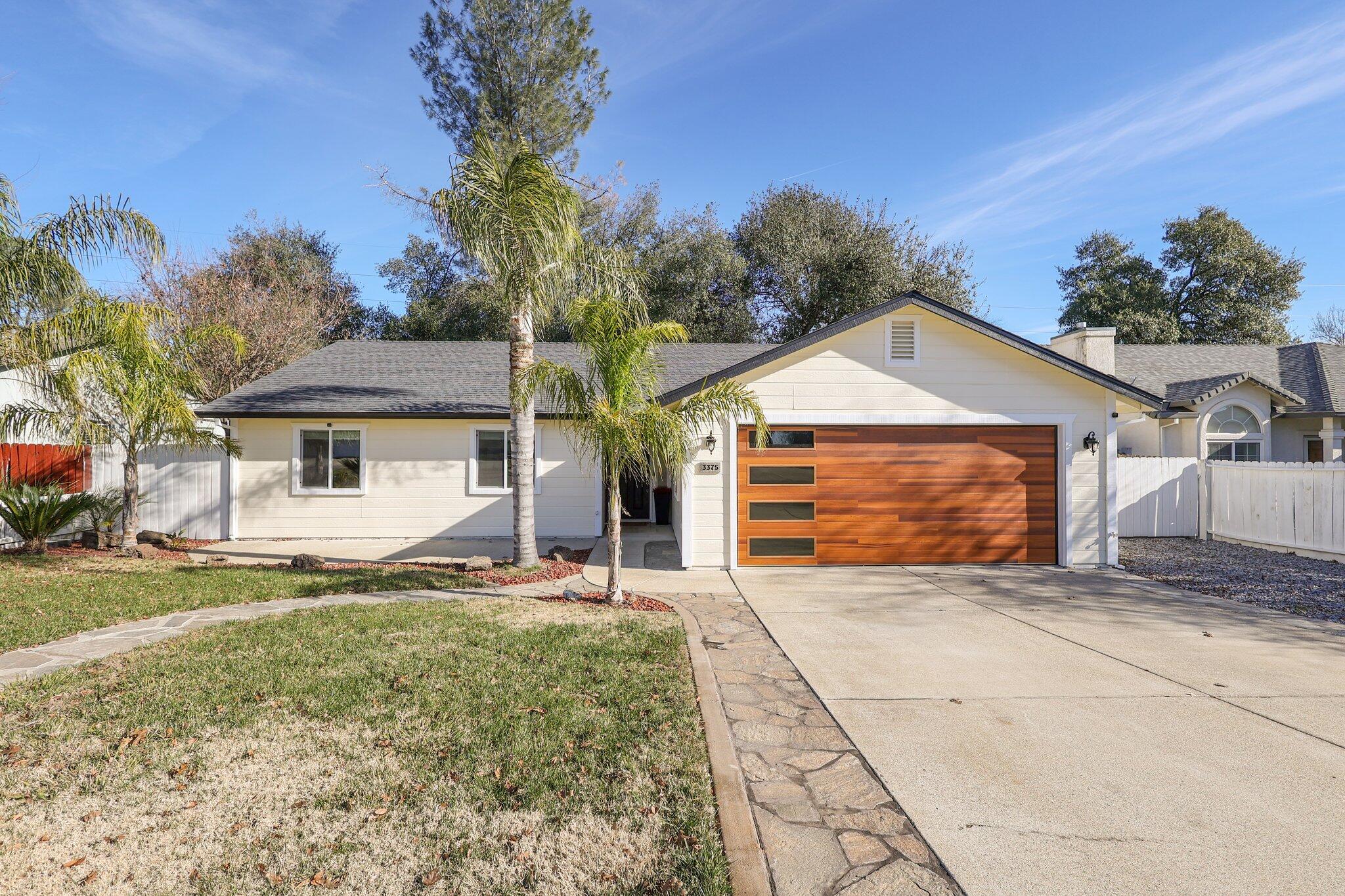 3375 Lawrence Road Redding, CA 96002 - Photo 44 of 46 a front view of a house with a yard and garage