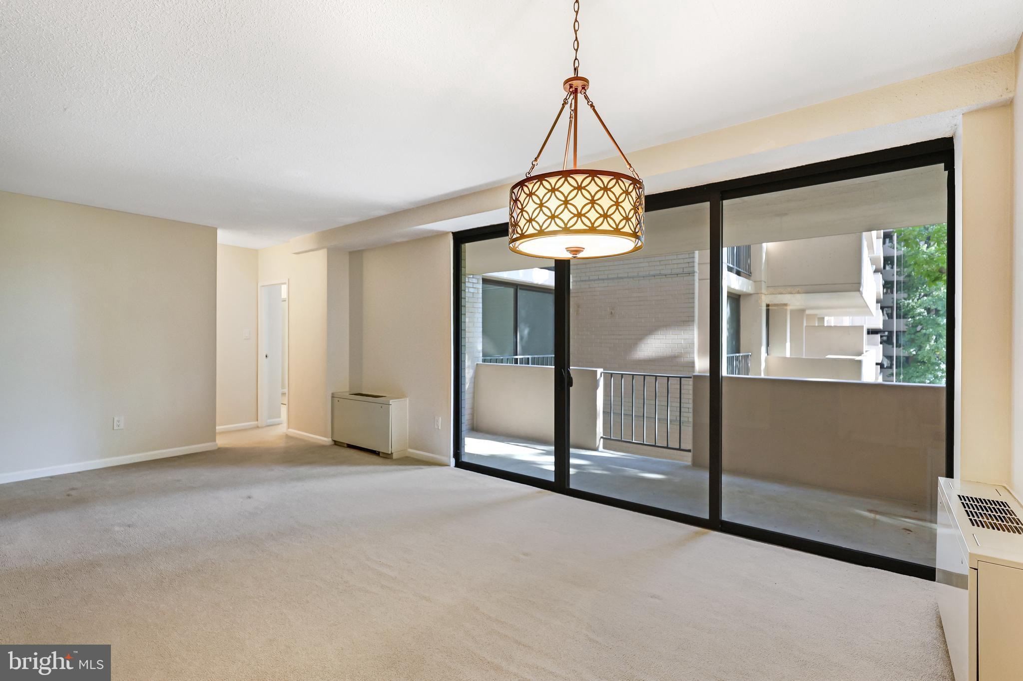 4141 North Henderson Road, Unit 303 Arlington, VA 22203 - Photo 13 of 41 Living Rm. & Dining Rm. open to appealing balcony