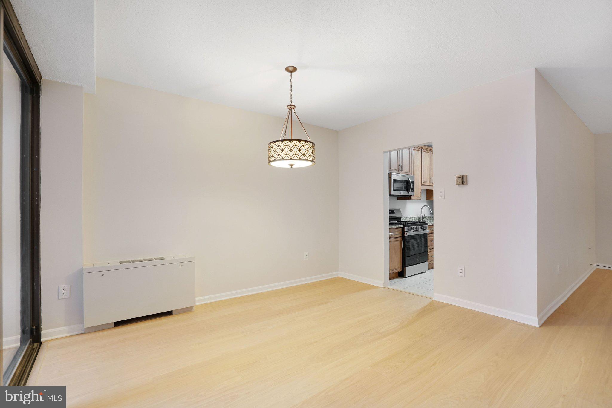 4141 North Henderson Road, Unit 303 Arlington, VA 22203 - Photo 24 of 37 a view of a room with a hanging light and kitchen