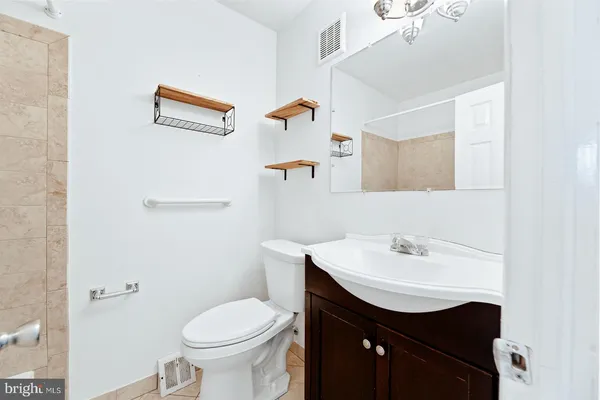 a bathroom with a sink toilet and a mirror