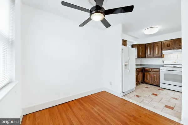 a view of kitchen with stainless steel appliances cabinets and wooden floor