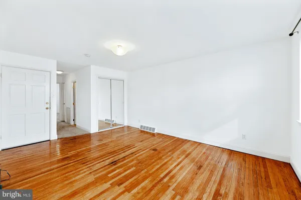 a view of an empty room and wooden floor