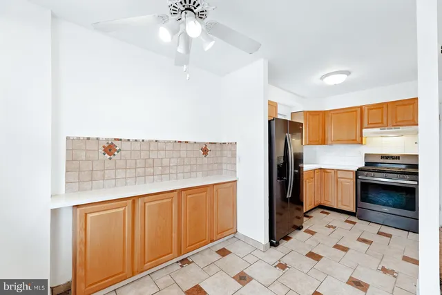 a kitchen with stainless steel appliances a refrigerator and cabinets